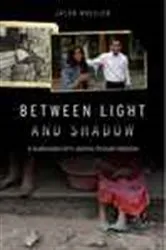 Book cover of Between Light and Shadow by Jacob R. Wheeler
